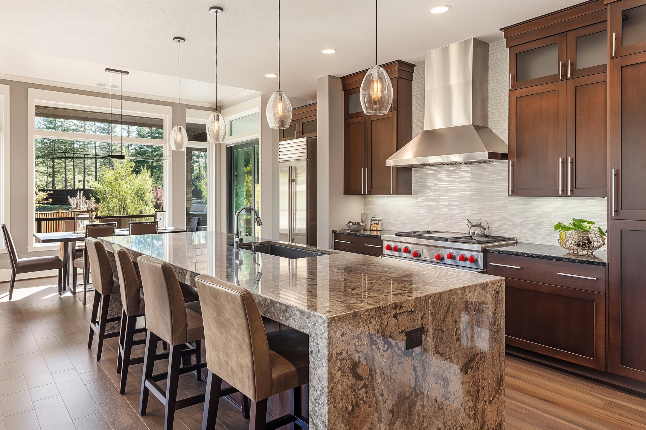Modern kitchen with an island and laminate floors.