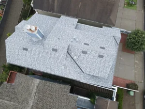 Aerial view of a newly installed gray shingle roof on a Bay Area home, showcasing expert roofing craftsmanship by Bayside Builders Group.