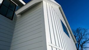 A modern residential building with white siding and a sleek window, showcasing Bayside Builders Group's expertise in high-quality siding and exterior home renovations in the Bay Area.