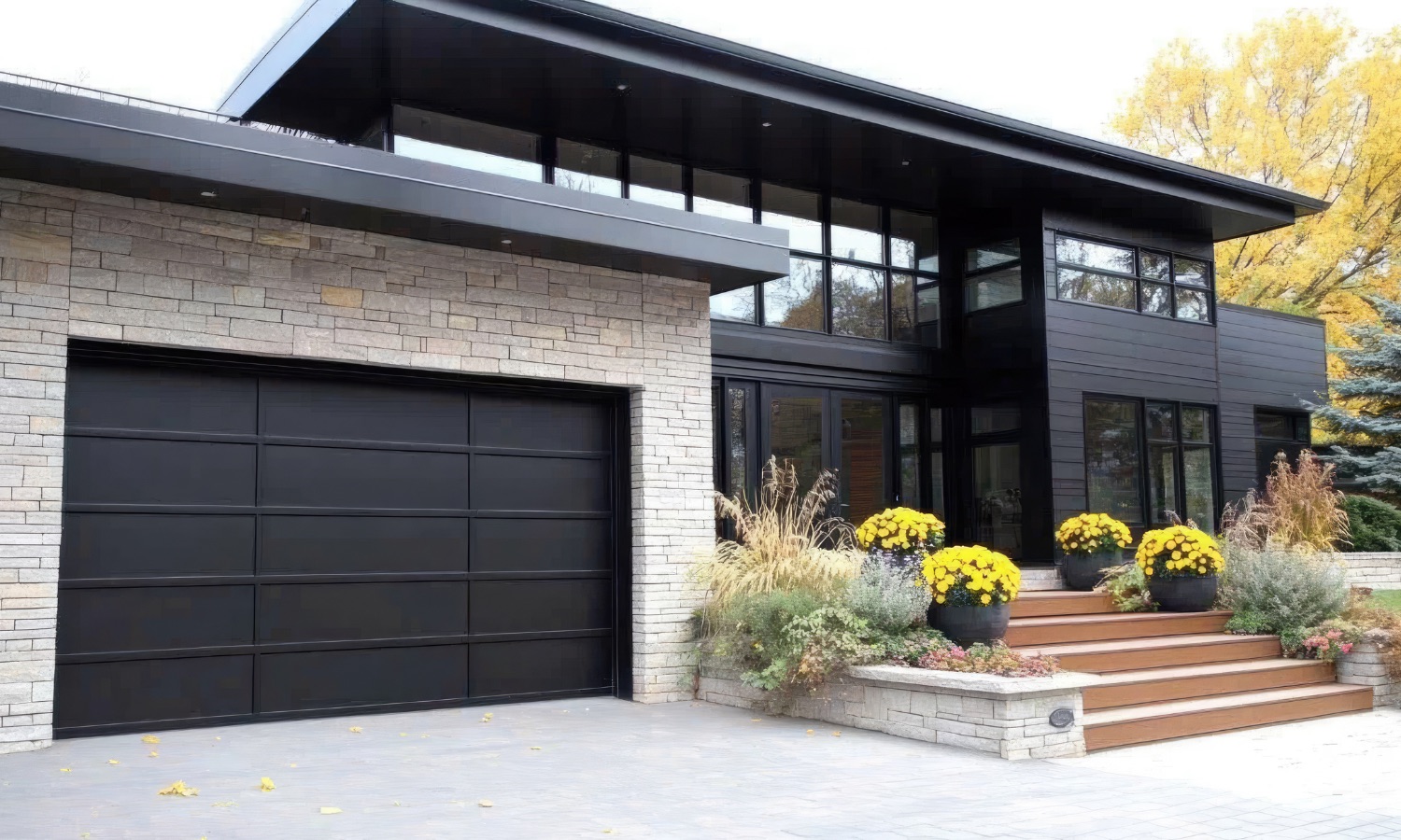 Modern Bay Area home featuring sleek black siding and spacious glass windows, exemplifying Bayside Builders Group's expertise in contemporary home remodeling and exterior design.